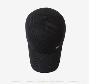 Top view of a black baseball cap featuring ribbed texture and a metal side logo