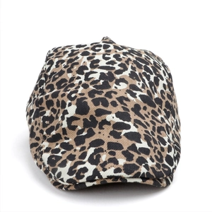 Close-up of leopard print newsboy cap showing dense twill texture and retro patterns