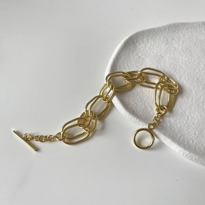 Macro detail of gold S925 sterling silver stamp on chunky chain bracelet with OT toggle
