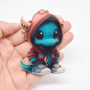 Close-up of a blue Christmas dragon acrylic pendant wearing a red hoodie ornament