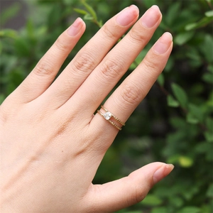 Detail of 18K gold-plated double-layer ring featuring a square zircon and milgrain texture