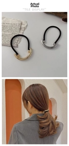 Minimalist brushed alloy hair tie featuring gold and silver curved metal tube decorations
