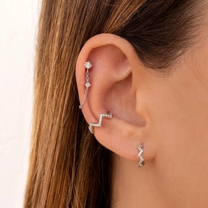 Close-up of S925 silver wavy ear cuff set with pavé cubic zirconia on model's ear