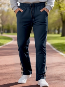 Detail of navy blue sports trousers with elastic waist and white side stripes on track