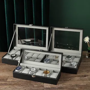 Luxury leather watch box with clear glass lid and metal lock on a vintage wooden desk