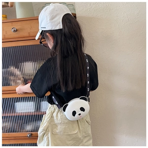 Cute white panda silicone crossbody bag worn by a girl against a textured background