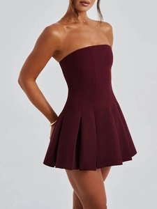 Macro detail of the dark red strapless pleated design on this elegant short evening dress
