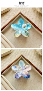 Close-up of plumeria hair claw clips with floral patterns and gradient textures