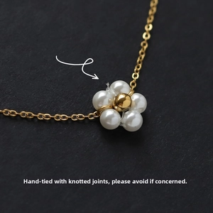 Macro detail of daisy flower pendant with white pearls and 18K gold plated steel chain