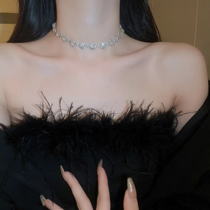 Detail view of a silver floral choker with sparkling rhinestones on a female model