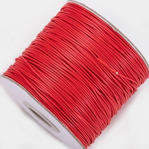 Macro view of bright red waxed polyester cord roll for leather sewing and DIY jewelry