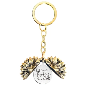 Macro view of sunflower keychain with engraved KEEP fucking GOING motivational text
