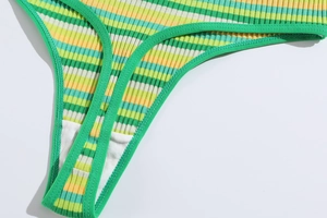 Close-up of ribbed knit texture and stitching on striped T-back thong underwear