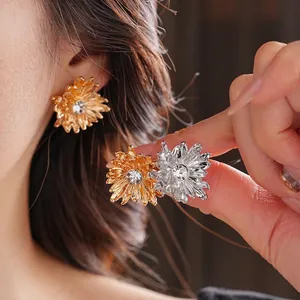 Elegant floral stud earrings with sparkling cubic zirconia in gold and silver finish