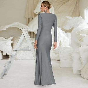 Detail view of the sleek back design of a slim-fit grey long-sleeve evening gown