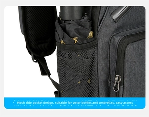 Detail of the side mesh pocket on the crossbody bag holding a black folding umbrella