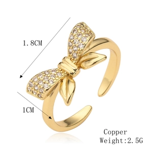 Detailed view of gold copper bow ring with zircon inlay, 1.8cm length and 2.5g weight