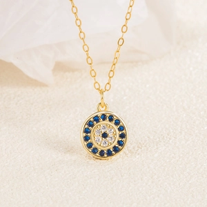 Macro view of gold S925 silver Evil Eye necklace with blue zircon pavé setting