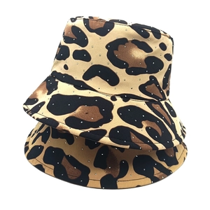 Fashionable leopard print bucket hat with rhinestone embellishments on a white background