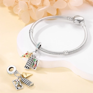 Close-up of silver charm bracelet with Italian landmarks like Leaning Tower of Pisa
