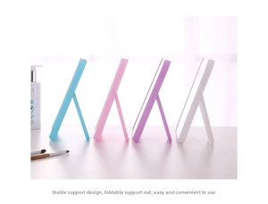 Detail view of foldable tabletop makeup mirror with stable support stand in four colors