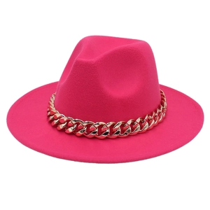 Detail of rose pink wool felt fedora hat with chunky gold acrylic chain decoration