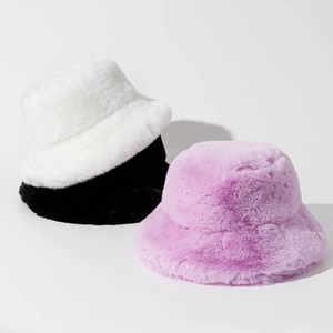 Thick plush bucket hats for winter in white, black and purple colors with soft faux fur texture