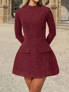 Detail of elegant burgundy tweed long sleeve mini dress featuring waist pockets and slim fit