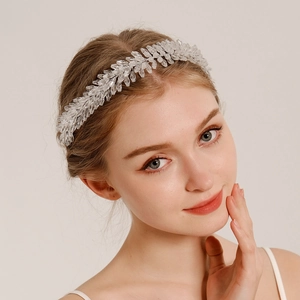 Detail of crystal bead woven leaf bridal headband elegantly worn on a model for wedding style