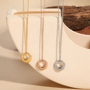 Minimalist circular ring pendants in gold, rose gold, and silver on O-chain necklaces