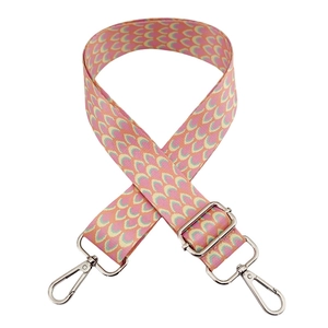 Detail of colorful adjustable shoulder strap with pink scales and silver metal hardware