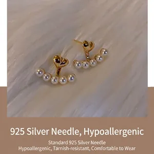 Elegant 925 silver needle heart stud earrings with curved white pearl drop design