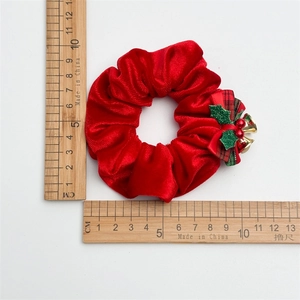 Red velvet Christmas scrunchie with bell and bow, size measurement shown on L-shaped ruler
