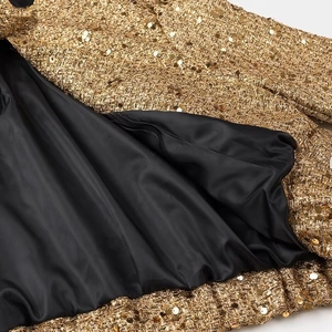 Giacca elegante con paillettes dorate e fodera nera liscia per un look da donna