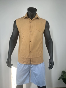 Close-up of mustard cotton linen sleeveless shirt texture with pocket and buttons