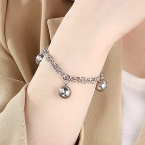 Detailed view of a silver titanium steel beaded bracelet on a woman's wrist