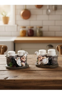 Detailed macro view of creative resin chef figurines holding white ceramic seasoning bottles