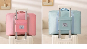 Detail of waterproof quilted travel bag showing back strap secured on suitcase handle