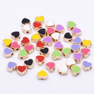 Macro shot of 8mm colorful heart enamel charms with side holes for DIY jewelry making