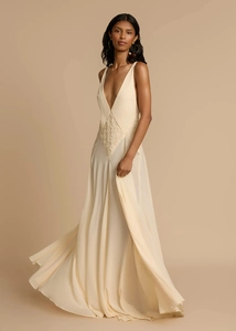 Detail of elegant V-neck lace patchwork on flowy beige summer maxi dress for women