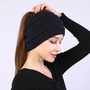 Close-up of knit ponytail headband in navy blue with detailed cable-knit texture