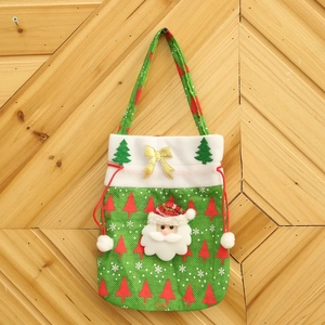 Christmas gift bag with Santa Claus, green fabric with red trees and gold bow decoration