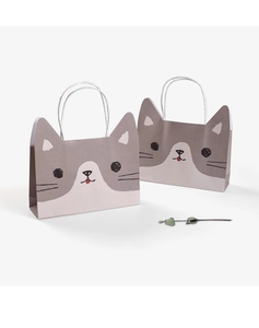 Detail of cute grey and white cat cartoon gift bags with white rope handles on plain background