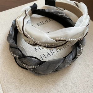 Detail of woven organza headbands with crystal bead chains in beige and silver grey