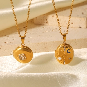 Detailed view of gold plated magnetic locket necklaces with celestial sun and moon designs