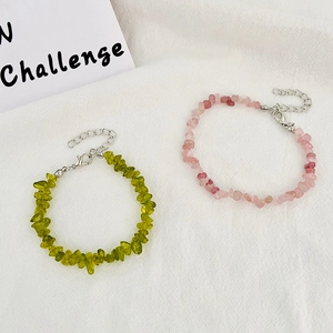 Detail of natural green and pink irregular stone bracelets with adjustable metal chain
