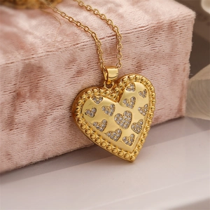 Macro shot of gold-plated heart pendant necklace with shimmering cubic zirconia stones
