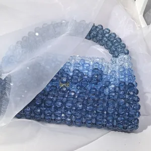Macro detail of handmade gradient blue acrylic beaded handbag with ice-like texture