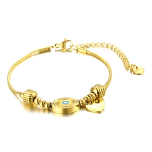 Golden stainless steel snake chain bracelet with evil eye and heart charms on white background