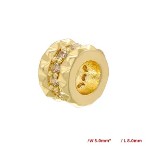 Macro shot of 5mm by 8mm golden honeycomb spacer bead with pavé zircon crystals